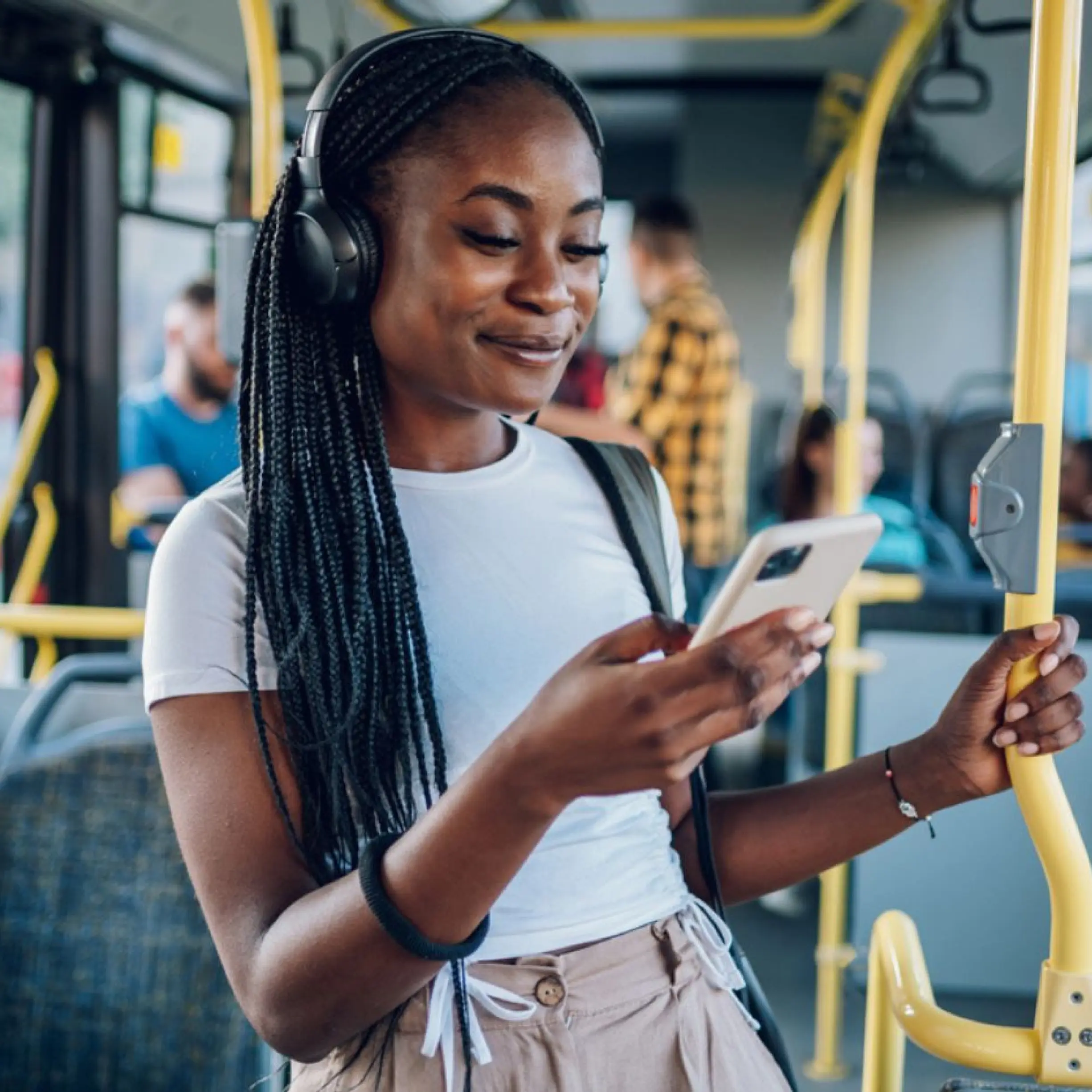 Person browsing listings on their phone while commuting